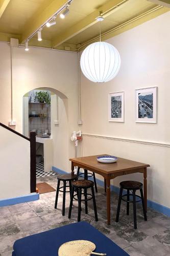 a dining room with a table and stools at BaanBaan - Cozy home 5pax, 5min BTS, Boat, old town explore in Bangkok