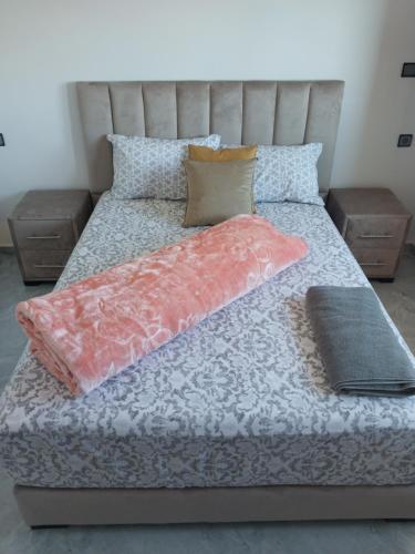 a bed with two pillows on top of it at Casa Salvador 1 boujdour in Cabo Bojador