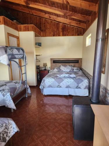 a bedroom with a bed and a wooden ceiling at Hospedaje Shuyen in Victoria