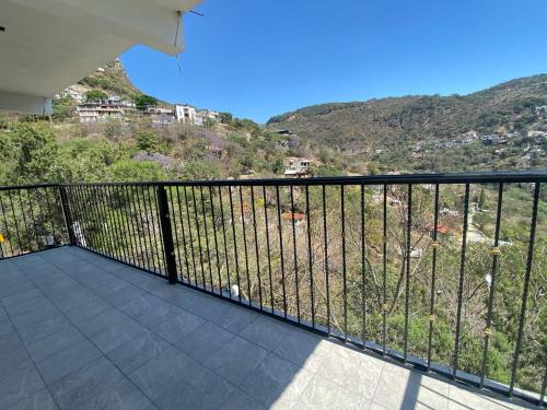 a balcony with a view of a mountain at Terrazas Hotel and Hostel in Taxco de Alarcón