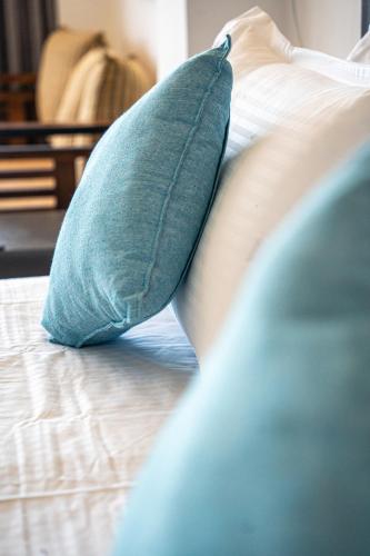a pillow sitting on top of a bed at Cocos in Midigama
