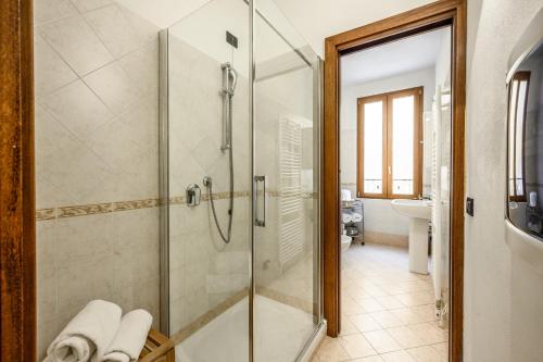 a bathroom with a shower with a glass door at Emilia Studios 8 in Modena