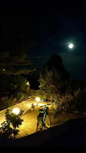 a bike parked in a park at night at Argiro's Studios A1 in Kefalos
