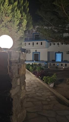 a house at night with a stone path in front at Argiro's Studios A1 in Kefalos