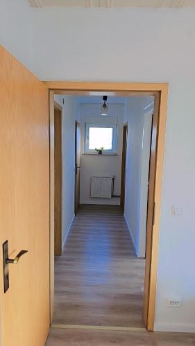 a hallway leading to a room with a window at Beautiful 3 Room big Apartment with kitchen and Balcony in Kerpen