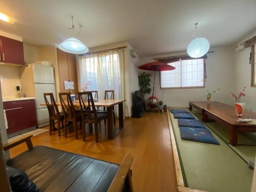 a kitchen and living room with a table and chairs at 新宿一軒家120平米 Jr新大久保駅徒歩3分 浴室2 トイレ2 歌舞伎町徒歩10分 駐車場無料 in Tokyo