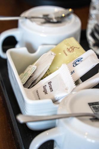 a tray with a container filled with spoons and cups at Cocos in Midigama