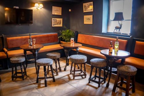 a row of tables and stools in a bar at Anglers Arms in Alnwick