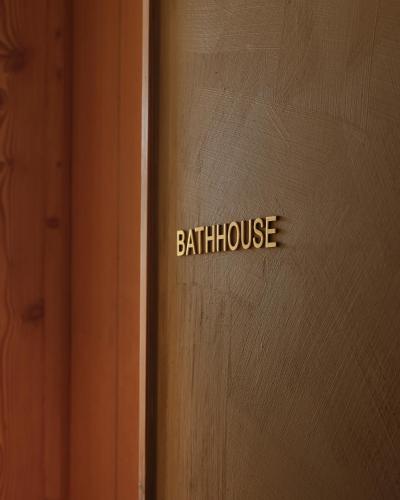a wooden door with the words bath house on it at Inness in Accord