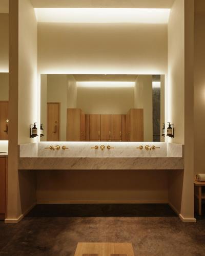 a bathroom with a large mirror and a sink at Inness in Accord