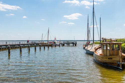 two boats are docked at a dock in the water at Am Kranichland in Wieck