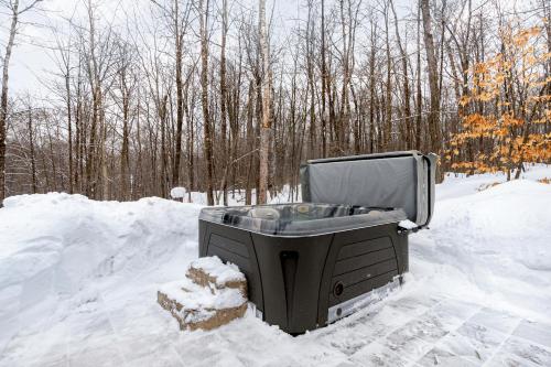 a tv sitting in a pile of snow at Chalet Berg-Haus by Rendez-Vous Mont-Tremblant in La Conception