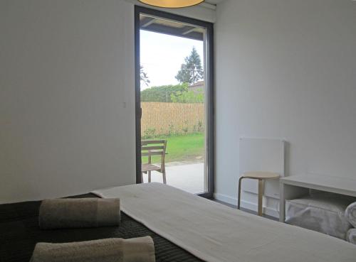 a bedroom with a bed and a sliding glass door at Furnas Valley in Furnas