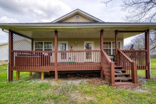 a house with a large deck on a yard at Lee's Creekside in Pigeon Forge