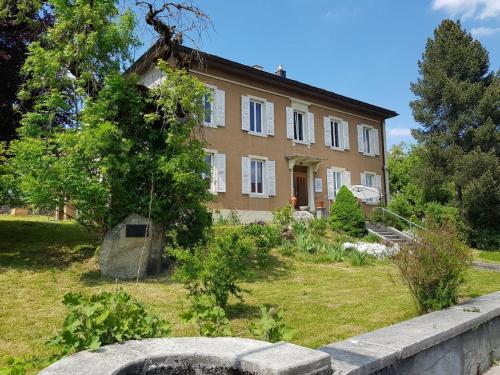a large house with a garden in front of it at Maison 1902 in Tramelan