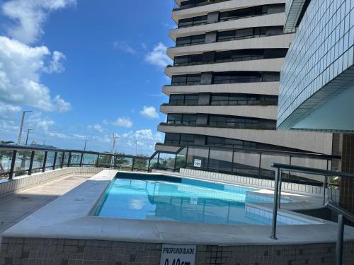 una piscina di fronte a un edificio alto di Chic hotel suite in fabulous Meireles Fortaleza with WiFi, fitness room a Fortaleza