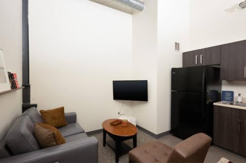 a living room with a couch and a table at Cream City 2BR Apt - Just 3 Blocks to Fiserv with Gym and Parking in Milwaukee