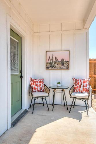 a porch with two chairs and a table and a door at Bismarck Farm 2 BR 2 and a half BA New in San Angelo