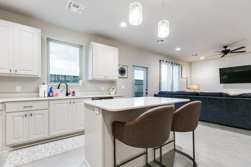 a kitchen with white cabinets and chairs and a couch at Holiday Haven with 3 BR and 2 BA New in San Angelo