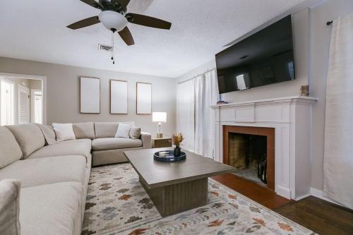 a living room with a couch and a fireplace at 4 BR with 3 BA Turf Backyard New in San Angelo