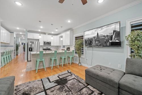 a kitchen and living room with a couch and a table at Skyline Haven Luxe NYC Escape in Jersey City