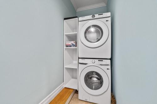 a washer and dryer in a corner of a room at Skyline Haven Luxe NYC Escape in Jersey City