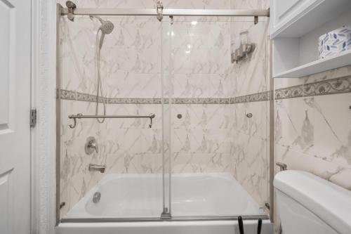 a bathroom with a shower with a tub at Skyline Haven Luxe NYC Escape in Jersey City