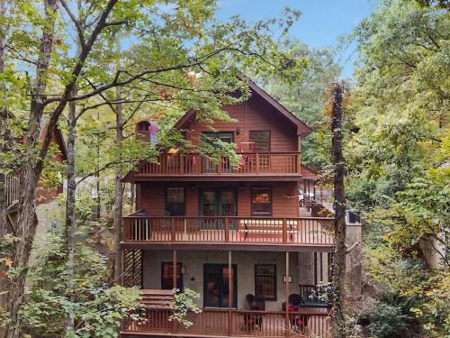 a large wooden house in the middle of trees at Forest Hollow in Pigeon Forge