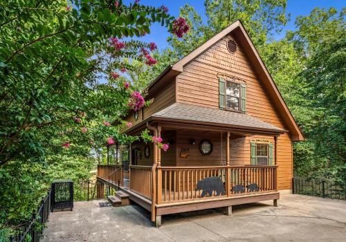 a large wooden house with a large deck at Forest Hollow in Pigeon Forge