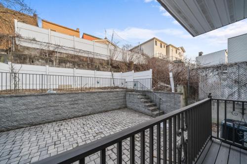 a balcony with a staircase and a fence at Skyline Haven Luxe NYC Escape in Jersey City