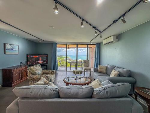 a living room with a large couch and a table at East End Oasis - Hidden Gem 3BR-2BA Ocean Views in Christiansted