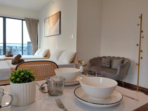a living room with a table with bowls on it at K Avenue Modern Style Studio (5 Mins to Airport) in Kota Kinabalu