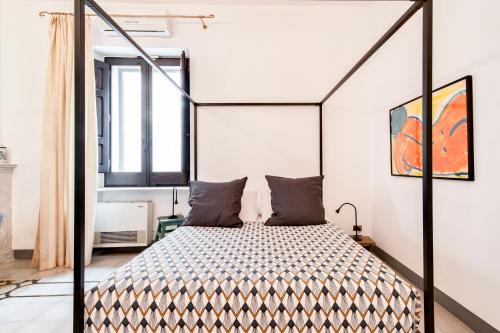 sypialnia z łóżkiem z czarną ramą w obiekcie Loft Ru - Lecce Selection w mieście Lecce