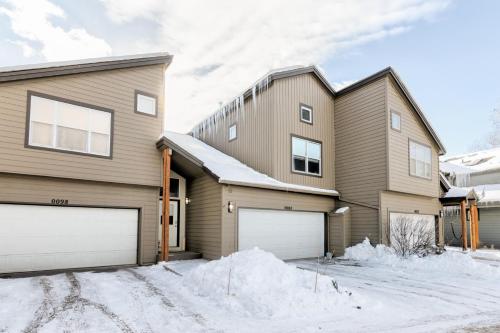 a house with two garage doors in the snow at Perfectly Located 3 Bed 3.5 Bath Beautiful Townhome in Edwards