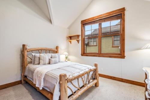 a bedroom with a wooden bed and a window at Cozy Spacious Mountain Home Close To Everything in Minturn