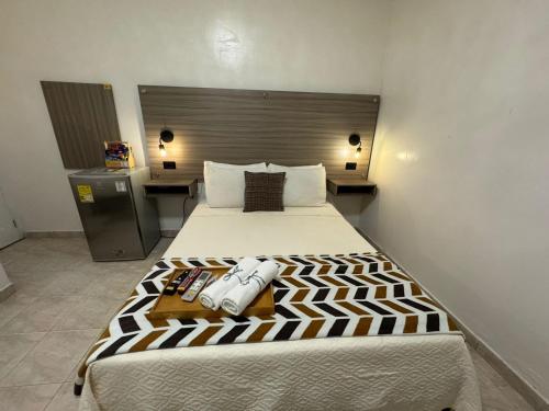 a bedroom with a large bed in a room at Hotel la Sierra Riohacha II in Ríohacha