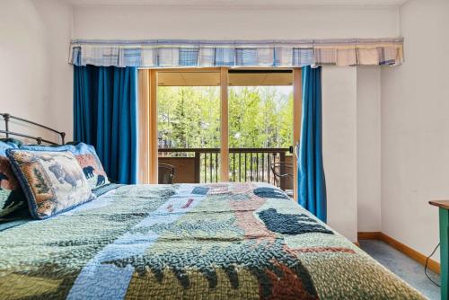 a bedroom with a bed and a large window at Perfectly Located Vail Home Hot Tub On Bus Lines in Vail