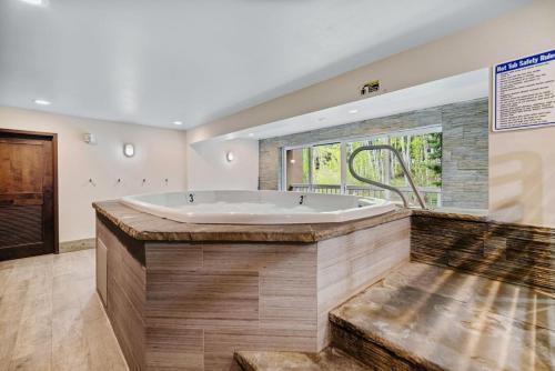 a large bathroom with a tub and a window at Perfectly Located Vail Home Hot Tub On Bus Lines in Vail