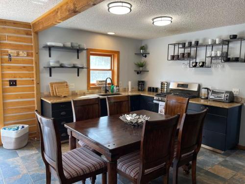 a kitchen with a wooden table and chairs in it at Cozy Mountain Cabin W Hot Tub Breathtaking Views in Alma