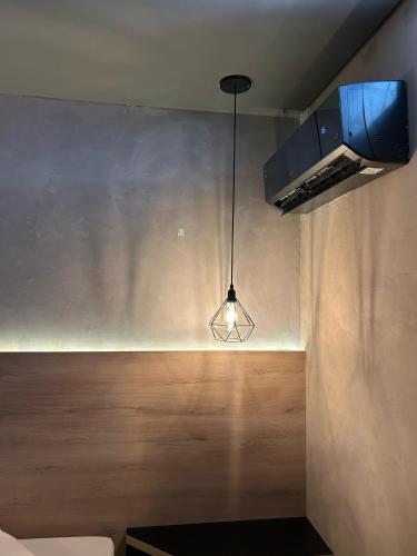 a light hanging from a ceiling in a room at Wish Motel in Campinas