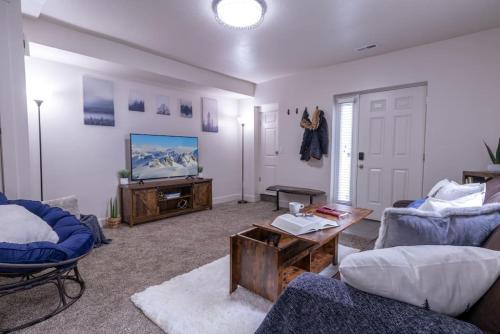 a living room with a couch and a tv at Cozy Relaxing Retreat Near Downtown SLC in Salt Lake City