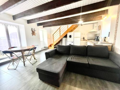 a living room with a couch and a table at Theven Plages in Santec