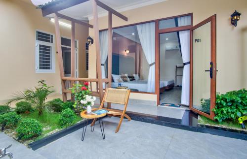 a room with a bed and a table and a chair at House of Pi Pleiku in Pleiku