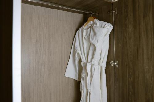 a white dress hanging on a rack in a room at Rado Hotel - Quintanas in Trujillo