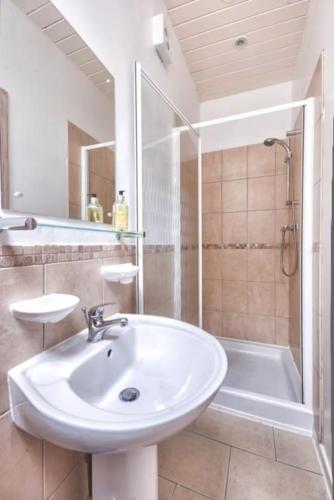 a bathroom with a sink and a shower and a tub at Finest Retreats - Town End Barn in Buxton