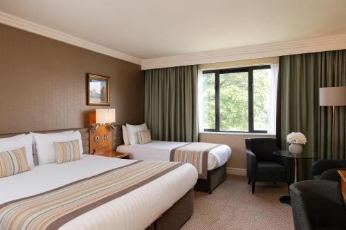a hotel room with two beds and a window at Roe Valley Resort in Limavady