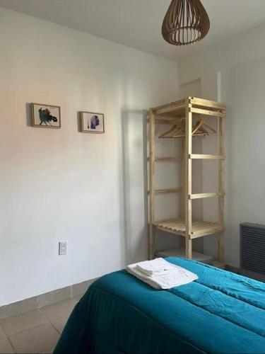 a room with a bed and a book shelf at Morada Las Caléndulas in Ushuaia
