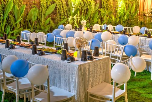 a set up for a party with blue and white tables and chairs at House of Pi Pleiku in Pleiku