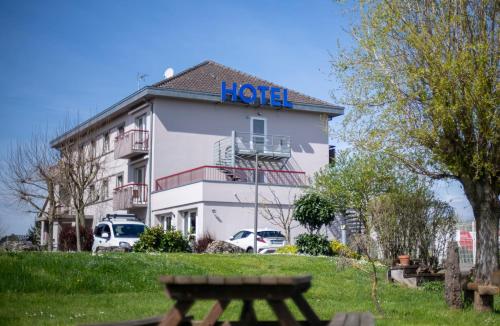a hotel building with a sign on top of it at Logis Hôtel & Restaurant Au Lion d'Or in Burnhaupt-le-Haut