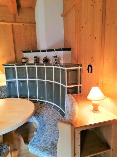 a kitchen with a stove and a table with a lamp at Ferienwohnung Bergblick in Kössen